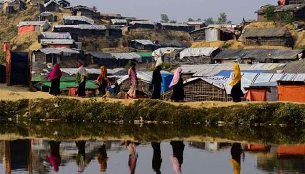 Rohingya refugees walk back to their homes at Balukhali camp in Ukhia, Bangladesh on Wednesday.