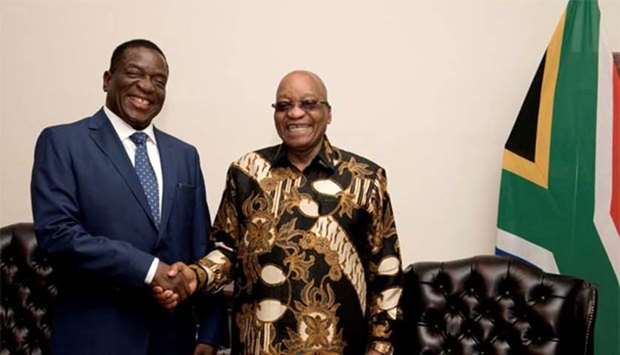 South African President Jacob Zuma (right) shakes hands with Zimbabwe's former vice president Emmerson Mnangagwa in Pretoria on Wednesday.