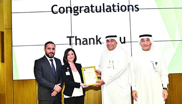 Ashghal officials receiving ISO 9001:2015 certification from officials of Afnor Groupe