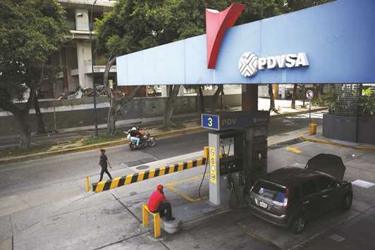 The logo of PDVSA is seen at a gas station in Caracas, Venezuela. The Opec-memberu2019s economy has collapsed since crude prices plummeted in 2014, forcing it to delay payments for oil services and fuel supplies.