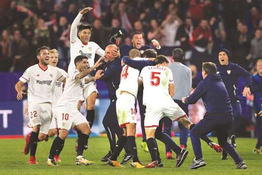 Sevillau2019s Guido Pizarro celebrates with teammates after scoring the third goal against Liverpool in the Champions League group stage match at Ramon Sanchez Pizjuan stadium in Seville, Spain. on Tuesday night. (Reuters)