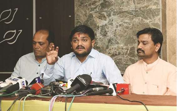 Patidar Anamat Andolan Samiti (PAAS) leader Hardik Patel (centre) speaks during a press conference in Ahmedabad yesterday. Patel announced his support to the Congress Party for the forthcoming Gujarat election.