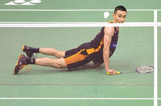 Malaysiau2019s Lee Chong Wei watches his shot against Chinau2019s Tian Houwei after he slipped during their first round match at the Hong Kong Open yesterday. The Malaysian won 21-9, 21-7. (AFP)