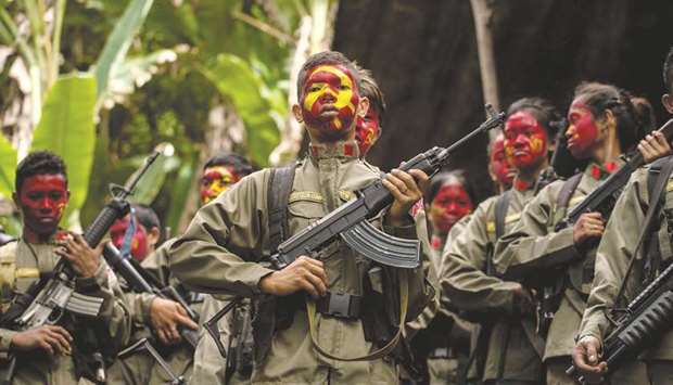 File photo shows guerrillas of the New Peopleu2019s Army (NPA) in formation in the Sierra Madre mountain range, located east of Manila.