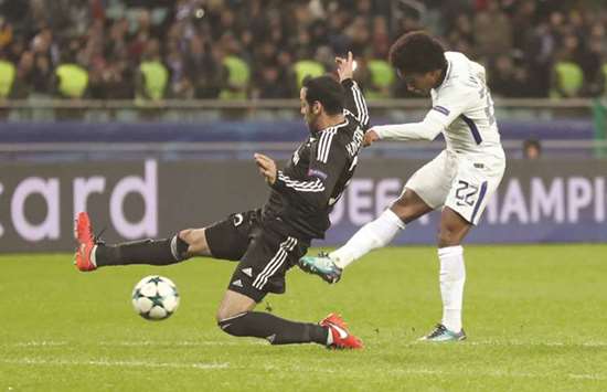 Chelseau2019s Willian (right) shoots to score their fourth goal in the UEFA Champions League match against Qarabag in Baku, Azerbaijan, yesterday. (Reuters)
