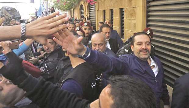 Lebanese prime minister Saad Hariri greets his supporters upon his arrival at his home in Beirut yesterday.