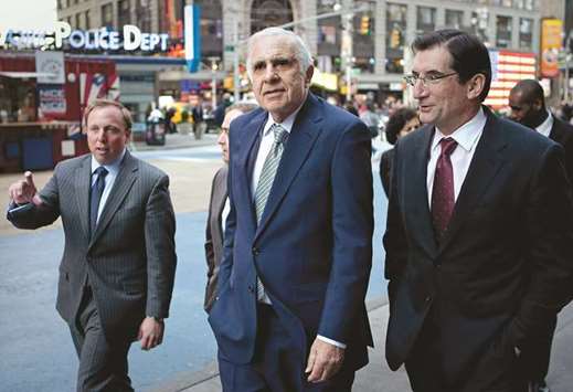 Carl Icahn, billionaire investor and chairman of Icahn Enterprises Holdings (centre), walks outside of the Nasdaq MarketSite with Robert Greifeld, CEO and president of Nasdaq OMX Group, in New York. Icahn, the majority owner of CVR Energy Inc, had complained that the US biofuel mandate is u201criggedu201d and the changes were urgently needed.