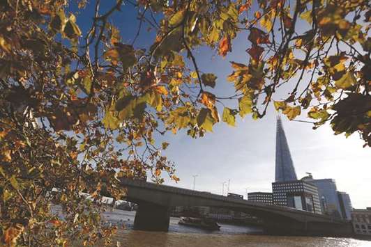 Autumn leaves hang from a tree on the north side of the River Thames opposite skyscraper The Shard in London (file). Qatar-owned Shardu2019s 26-floor office complex is now fully let, home to 31 businesses across a wide range of sectors including energy, manufacturing, retail, technology, finance, education, healthcare and professional services.