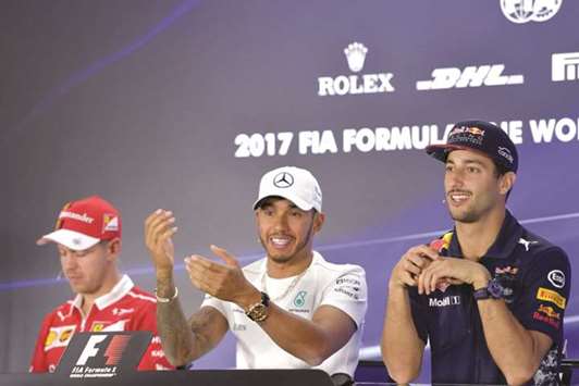 (L to R ) Ferrariu2019s German driver Sebastian Vettel, Mercedesu2019 British driver Lewis Hamilton and Red Bullu2019s Australian driver Daniel Ricciardo attend the drivers press conference ahead of the Abu Dhabi Formula One Grand Prix at the Yas Marina circuit yesterday. (AFP)