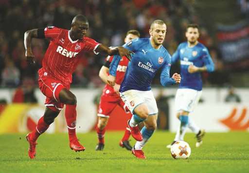 Arsenalu2019s Jack Wilshere and Cologneu2019s Sehrou Guirassy (left) vie for the ball during the Europa League match in Cologne, Germany. (Reuters)