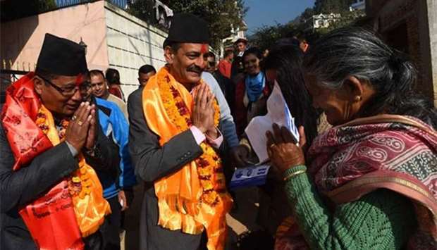 Nepali Congress and Democratic alliance election candidate Nabindra Raj Joshi (centre) gesturing as he takes part in a door-to-door election campaign in Kathmandu.