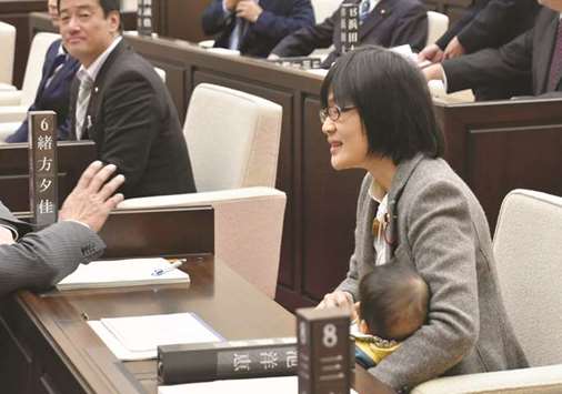 Kumamoto City assembly member Yuka Ogata holds her seven-month-old baby during a session in Kumamoto, Kumamoto Prefecture, Japan.