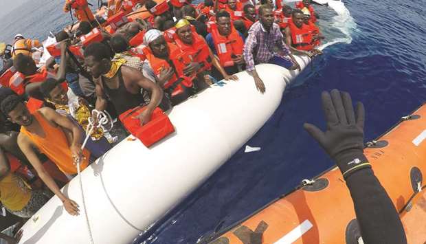 This picture taken on June 17 shows migrants on a dinghy being rescued by u2018Save the Childrenu2019 crew from the ship Vos Hestia in the Mediterranean sea, off the Libyan coast.