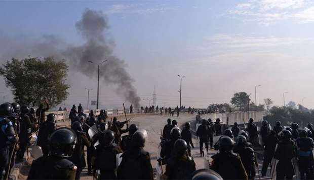 Pakistani riot police face off with protesters of the Tehreek-i-Labaik Yah Rasool Allah Pakistan (TLYRAP) religious group during a protest in Islamabad