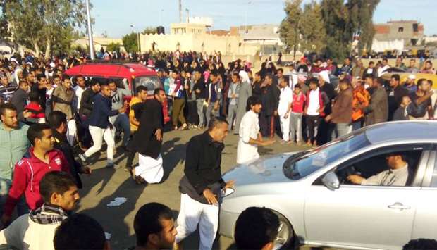 Egyptians gather at the site of a gun and bombing attack that targeted the Rawda mosque