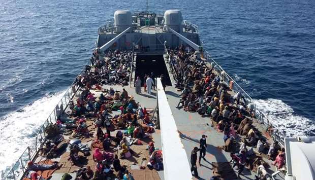 Migrants arrive at a naval base after they were rescued by the Libyan coastal guard in Tripoli.