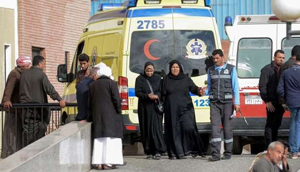 Relatives of the victims of the bomb and gun assault on the North Sinai Rawda mosque walk past an ambulance while waiting outside the Suez Canal University hospital in the eastern port city of Ismailia.