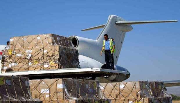 A technician unloads doses of vaccines from a plane after it landed in the rebel-held Yemeni capital Sanaa.