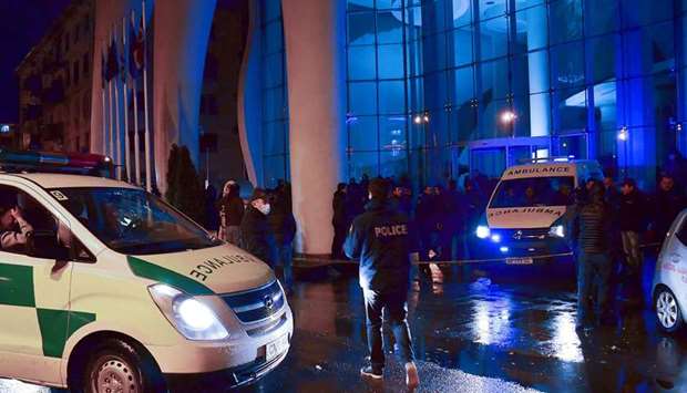 Police investigators and ambulance vans are seen in front of the Leogrand hotel in Georgiau2019s Black Sea resort city of Batumi late on Friday.
