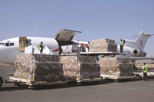 Workers unload aid shipment from a plane at the Sanaa airport, Yemen, yesterday.
