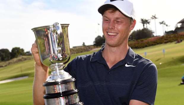 Cameron Davis of Australia holds up the trophy after winning the Australian Open