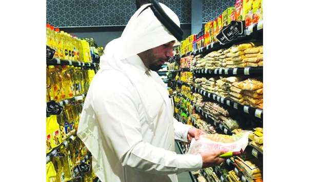 An inspector from the MEC going through some of the products stocked at an outlet