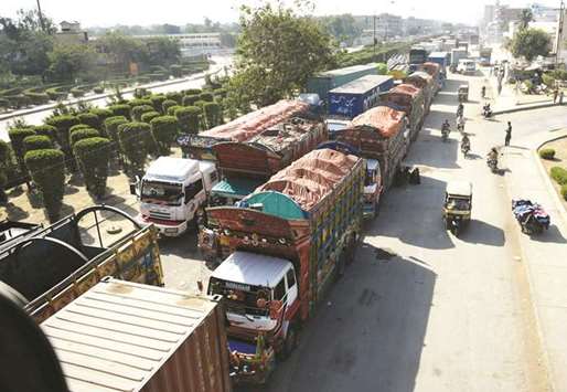 Trucks wait on a Karachi highway blocked by TLYRAP supporters.