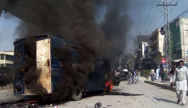 A burning prison van torched by protesters from the Tehreek-i-Labaik Yah Rasool Allah Pakistan (TLYRAP) religious group during clashes with police in Rawalpindi