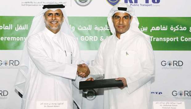 Dr Yousef al-Horr and Abdullah Saleh Abdulla Naser exchange the documents on MoU yesterday.