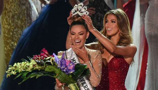 Miss South Africa 2017 Demi-Leigh Nel-Peters (L) reacts as she is crowned new Miss Universe 2017 by Miss Universe 2016 Iris Mittenaere