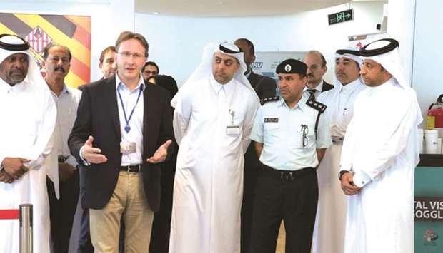 Total Qatar general manager Laurent Wolfschim speaking at the opening of the exhibition as officials from Mowasalat and the General Directorate of Traffic look on.