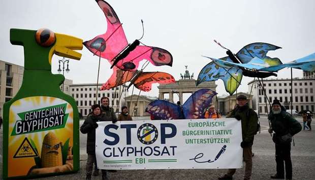 Environmentalists hold up giant butterfly mock-ups as they demonstrates against the use of glyphosate herbicides in agriculture