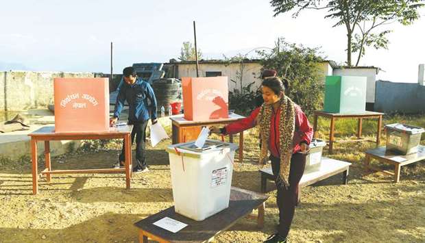 A woman casts her vote at a polling station during the general election at Chautara, Sindhupalchowk, district some of 100km east of Kathmandu, yesterday.