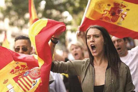 This picture taken on September 30 shows protesters with Spanish flags during a demonstration in Barcelona against independence in Catalonia. The illegal referendum was held the next day.