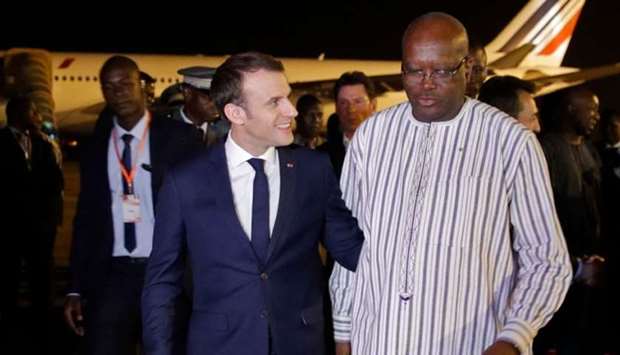 French President Emmanuel Macron is welcomed by Burkina Faso's President Roch Marc Christian Kabore (R) 
