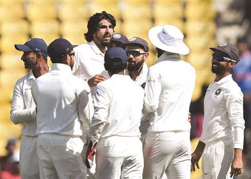 India's fast bowler Ishant Sharma (C) celebrates with teammates after taking the wicket of Sri Lanka batsman Niroshan Dickwella during the fourth day of the second Test in Nagpur on Monday. (AFP)