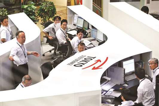 Employees work at the Tokyo Stock Exchange. The Nikkei 225 closed up 0.5% to 22,597.20 points yesterday.