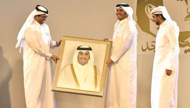 HE the Deputy Prime Minister and Foreign Minister Sheikh Mohamed bin Abdulrahman al-Thani being honoured by HE the Minister of Energy and Industry Dr Mohamed bin Saleh al-Sada at the event yesterday as QU president Dr Hassan al-Derham looks on.