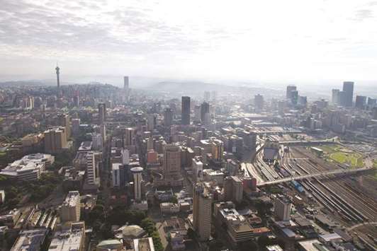 Traffic highways cross railway tracks in this aerial skyline view of commercial and residential property in Johannesburg (file). South Africau2019s plan to cut spending and raise taxes to stave off further debt downgrades may have unintended consequences u2013 stunting the economic growth that ratings companies are demanding.