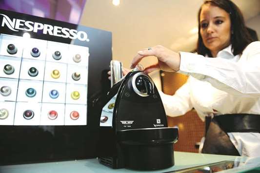 An employee uses a Nespresso coffee machine at a Nestle shareholdersu2019 meeting in Lausanne, Switzerland (file). The unit of Nestle, the worldu2019s largest coffee company, plans to purchase as much as five times more beans from the Caqueta region next year as part of a $50mn investment in sustainable high-quality production, the company said.