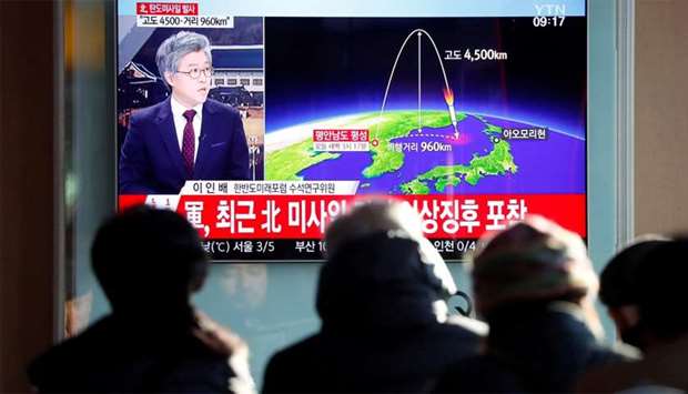 People watch a television broadcast of a news report in Seoul on North Korea firing what appeared to be an ICBM that landed close to Japan