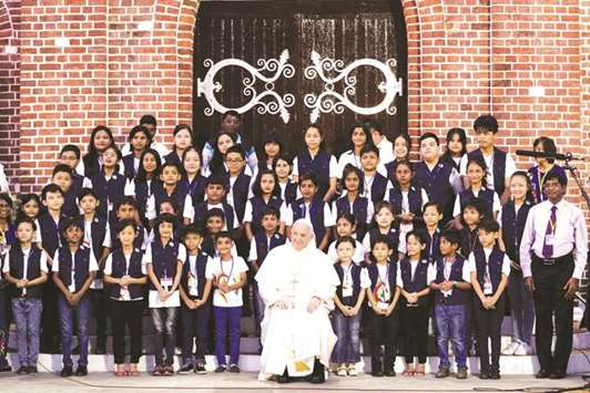 Pope Francis poses for a group photo with children as he arrives at St Maryu2019s Cathedral for a meeting with the bishops of Myanmar in Yangon yesterday.