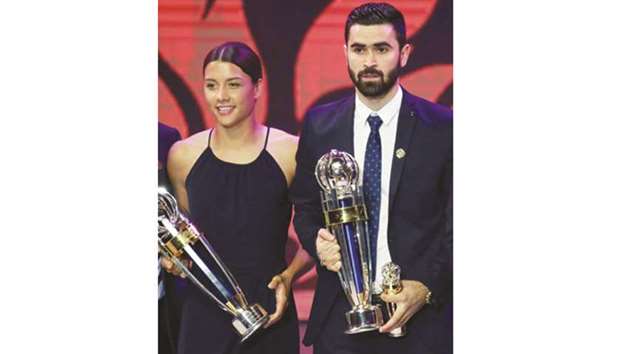AFC Womenu2019s Player of the Year Samantha Kerr (letf) of Australia, and Menu2019s Player of the Year Omar Khrbin of Syria pose after receiving their awards in Bangkok. (AFP)