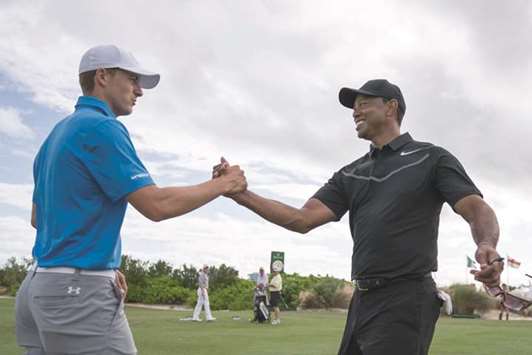 Jordan Spieth (left) shakes hands with Tiger Woods on the driving range during a practice round of the Hero World Challenge golf tournament at Albany. PICTURE: USA TODAY Sports