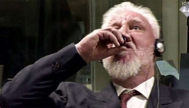 This videograb taken from live footage of the International Criminal Court, shows Croatian former general Slobodan Praljak swallowing what is believed to be poison, during his judgement at the UN war crimes court to protest the upholding of a 20-year jail term.