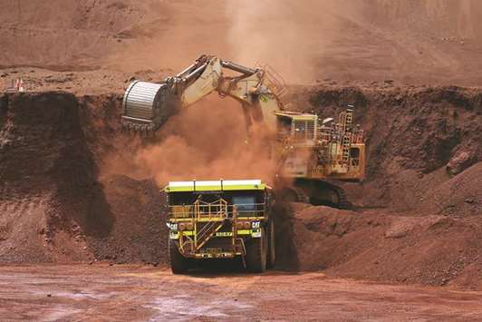 An excavator loads ore into an autonomous dump truck at Solomon Hub mining operations in the Pilbara region of Australia. More than 25 publicly-listed companies and legions of small prospectors are exploring for gold in Pilbara.