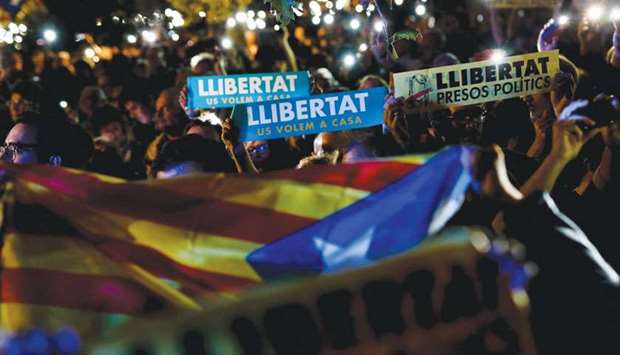 Protesters hold a Catalan pro-independence Estelada flag and signs reading u2018Freedom for political prisonersu2019 during a demonstration on Thursday evening outside the Catalonia parliament in Barcelona.