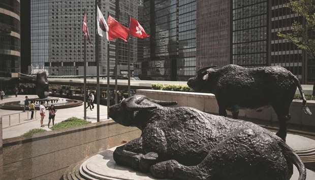 Bull statues are displayed outside the Hong Kong Stock Exchange. The Hang Seng closed up 0.3% to 28,603.61 points yesterday.
