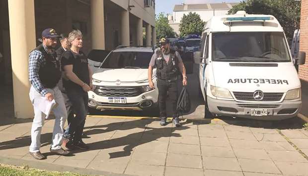 A handcuffed Amado Boduou (second left), is escorted by the naval police in Buenos Aires yesterday.