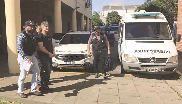 A handcuffed Amado Boduou (second left), is escorted by the naval police in Buenos Aires yesterday.